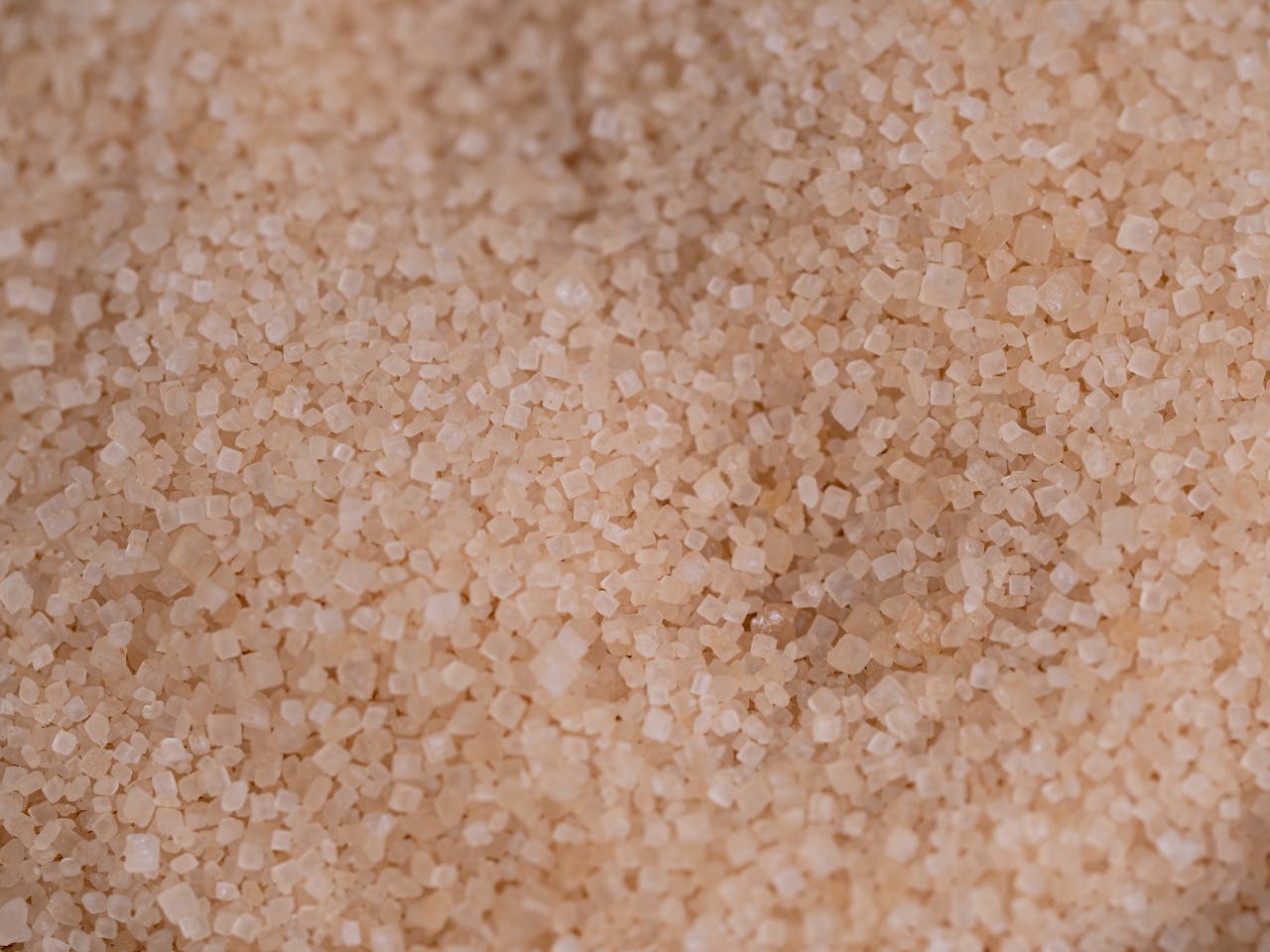 Macro capture of brown cane sugar showcasing texture and detail.